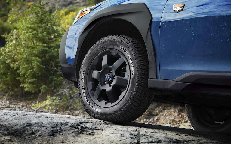 A close-up of the wheels of the 2022 Outback Wilderness showing the 9.5 inches of ground clearance.